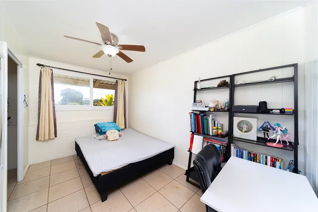a living room with baby crib furniture and a window