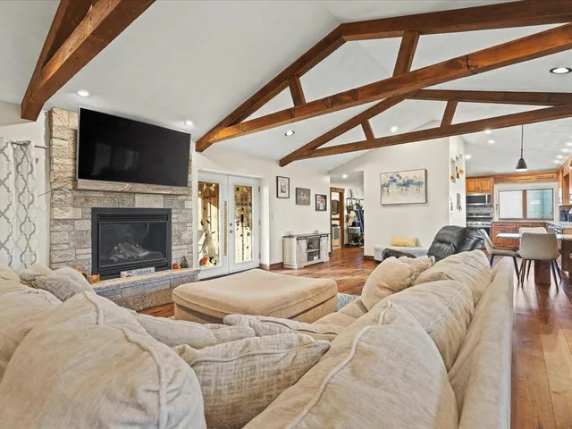 a large bedroom with a large bed and a flat screen tv