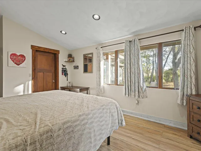 a bedroom with a bed and a large window