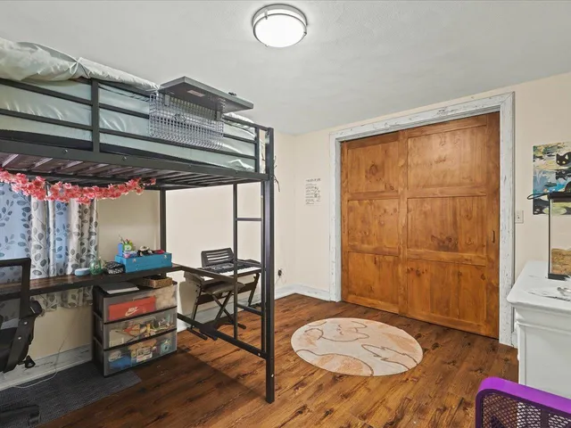 a view of a livingroom with furniture and floor to ceiling window