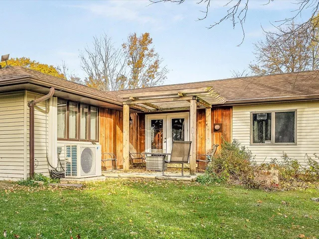 a view of a house with a yard and sitting area