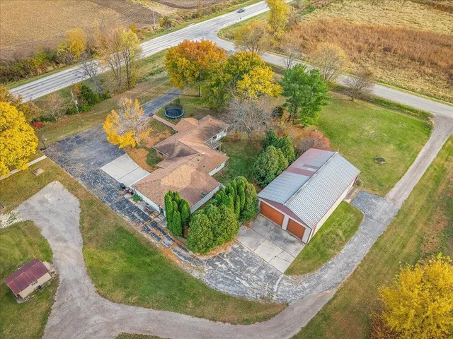 an aerial view of a house with a garden and swimming pool