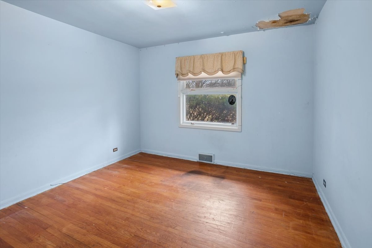 207 Town Acres Lane Roselle, IL 60172 - Photo 12 of 27 an empty room with window and wooden floor