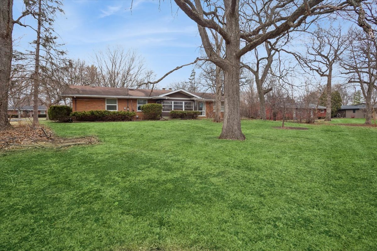 207 Town Acres Lane Roselle, IL 60172 - Photo 24 of 27 a house with huge green field in front of it