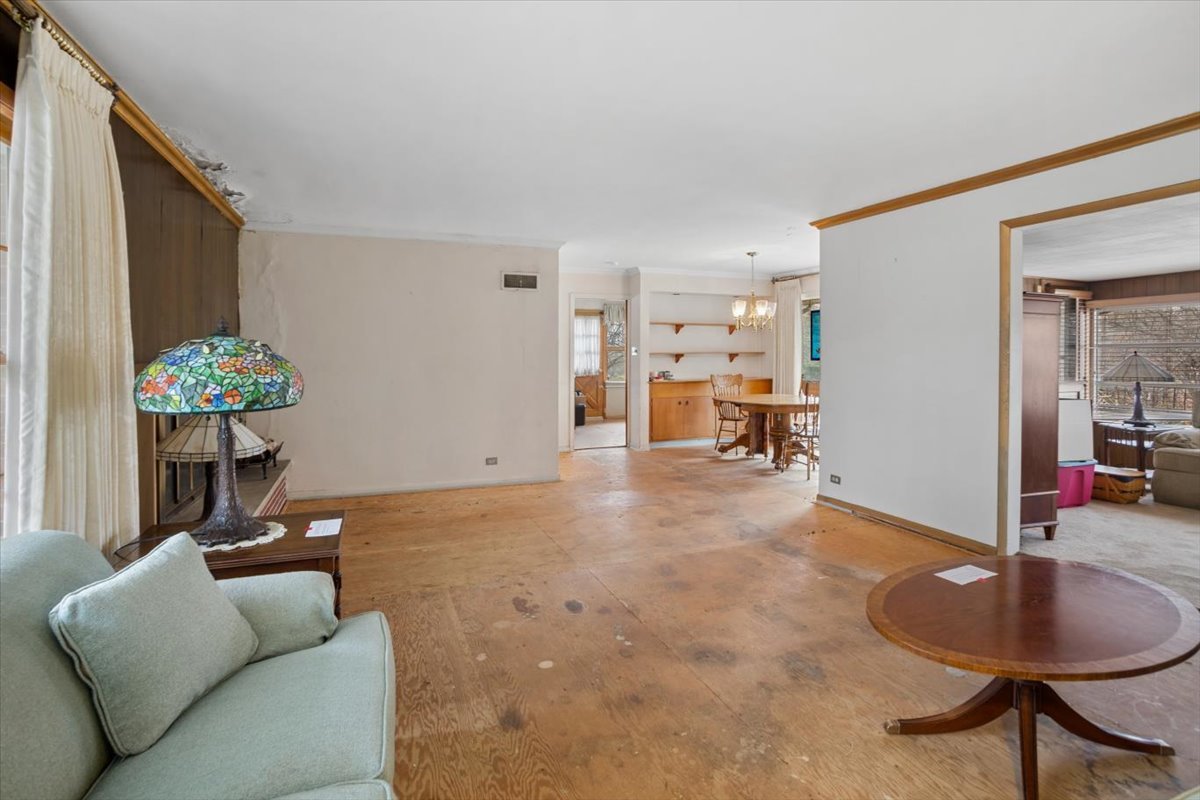 207 Town Acres Lane Roselle, IL 60172 - Photo 4 of 27 a living room with furniture and a chandelier