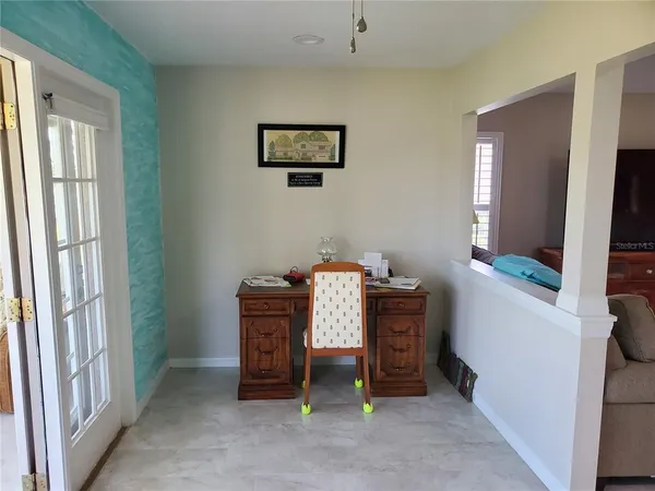 a view of a dining room with furniture and a kitchen