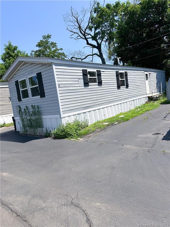 62 Fort Hill Road, Unit 10 Groton, CT 06340 - Photo 1 of 1 a house that has a tree in front of it