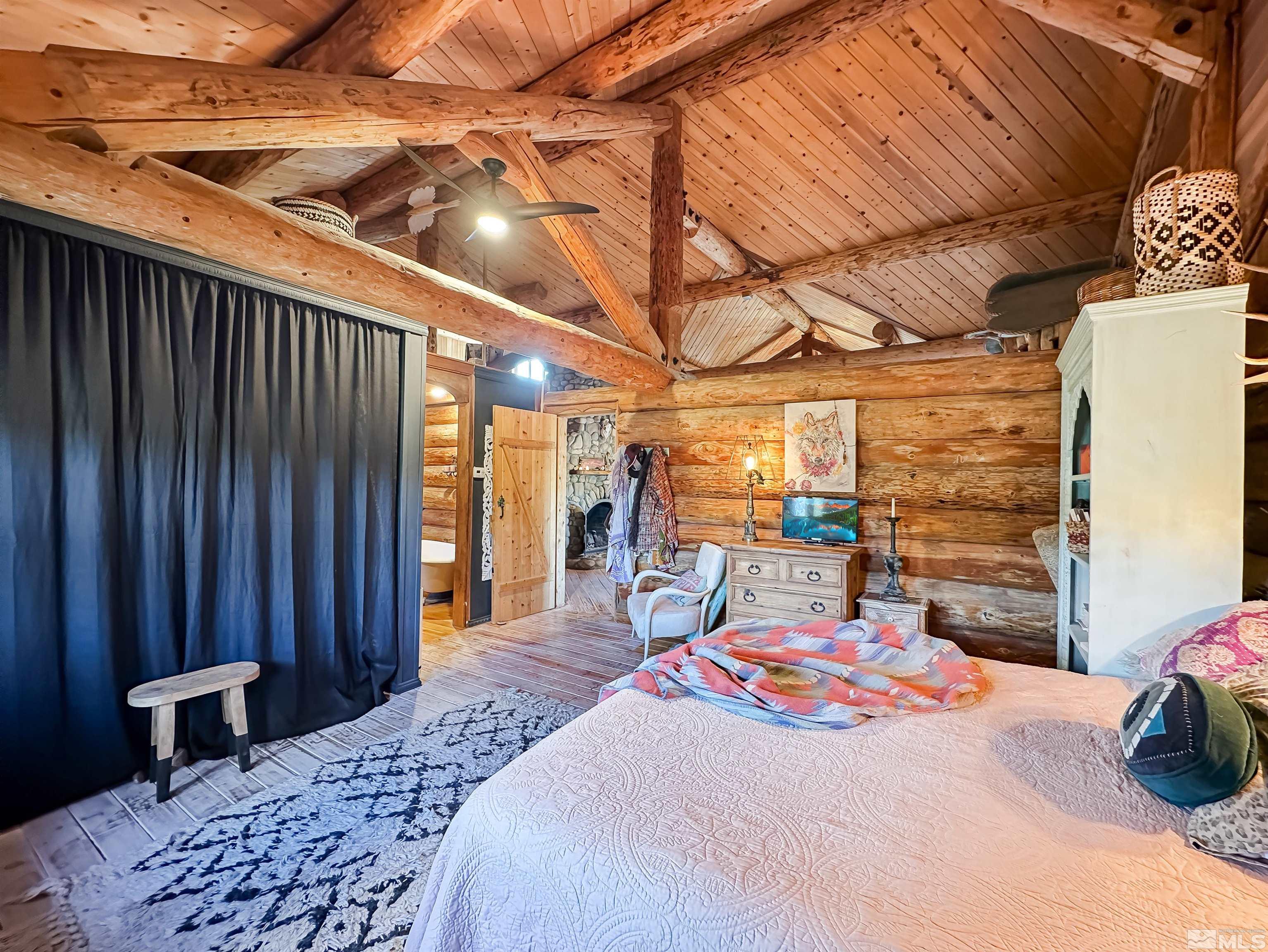 2428 Cartwright Road Reno, NV 89521 - Photo 19 of 39 a bedroom with a bed and wooden floor