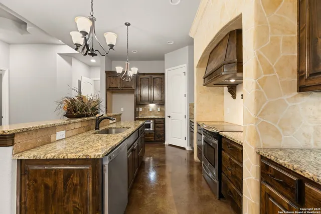 a kitchen with a sink cabinets and stainless steel appliances