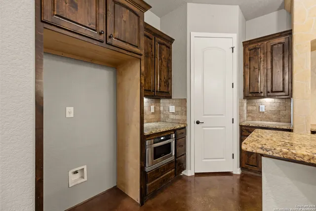 a kitchen with stove and refrigerator