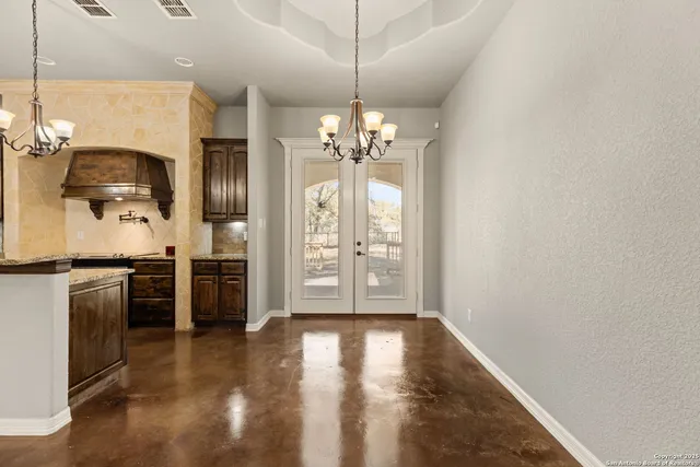 a bathroom with a granite countertop tub sink and mirror