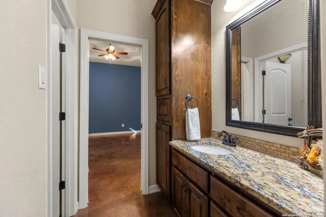 a bathroom with a sink toilet and mirror