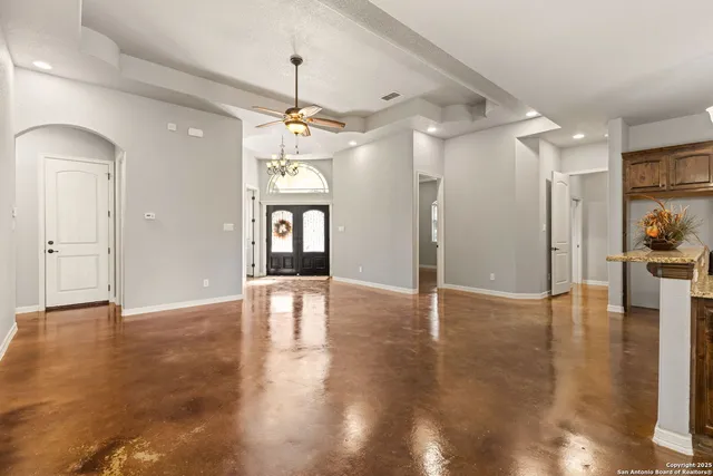 a kitchen with stainless steel appliances granite countertop a refrigerator a sink a stove and a wooden floors