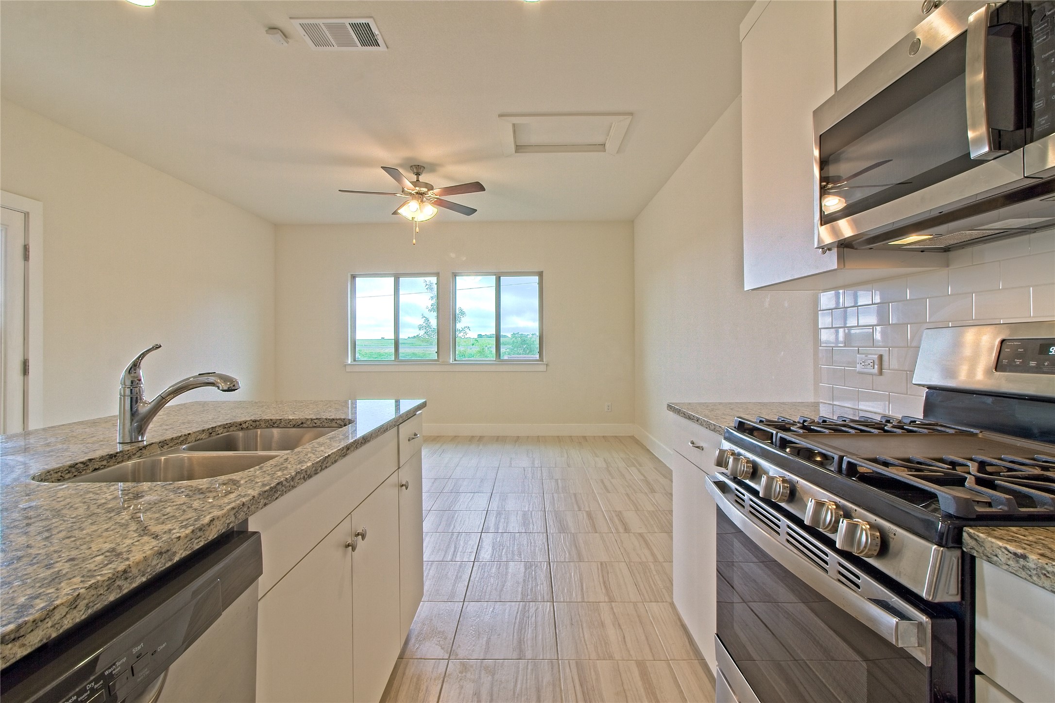 555 White Steppe Way Georgetown, TX 78626 - Photo 18 of 40 a kitchen with stainless steel appliances granite countertop a sink stove and cabinets