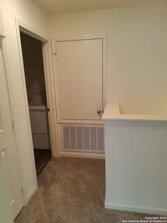 a utility room with cabinets washer and dryer