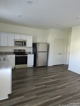 a view of kitchen with microwave and cabinets