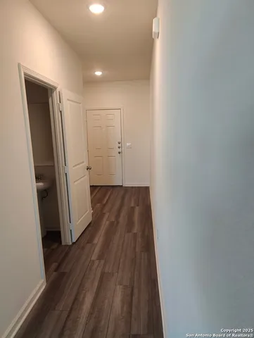 a view of hallway with wooden floor