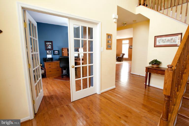 14410 Autumn Crest Road Boyds, MD 20841 - Photo 20 of 25 a view of a hallway with wooden floor and furniture