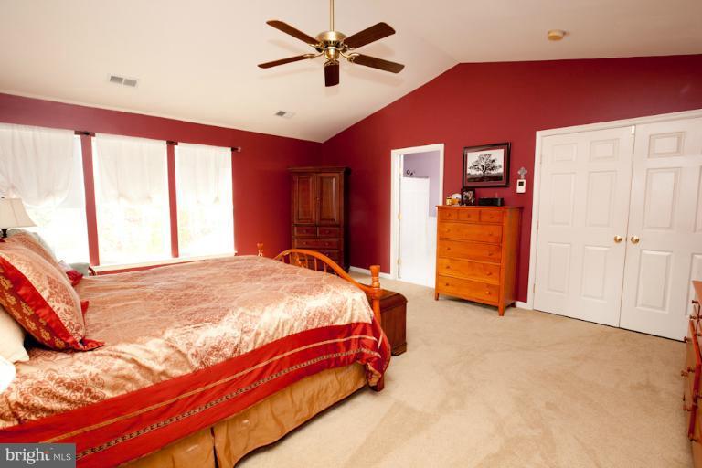14410 Autumn Crest Road Boyds, MD 20841 - Photo 3 of 25 a bed sitting in a spacious bedroom next to a window