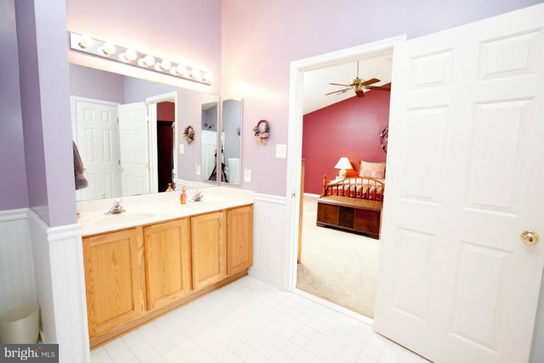 14410 Autumn Crest Road Boyds, MD 20841 - Photo 4 of 25 a bathroom with a double vanity sink mirror and