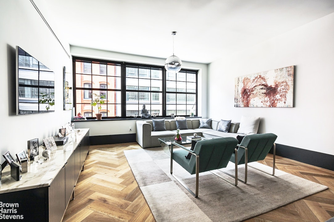 a living room with furniture and a large window