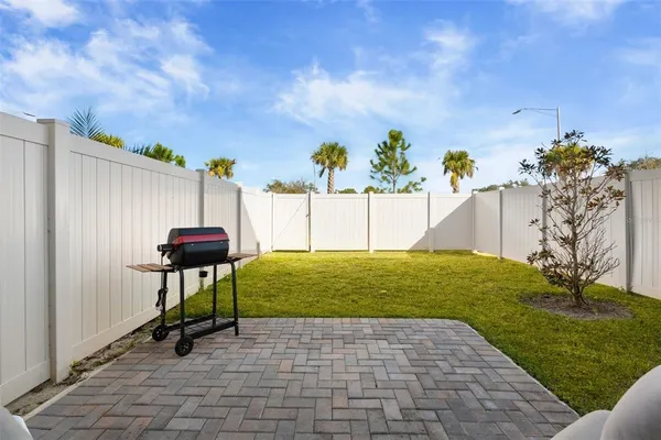 a view of a backyard with sitting area