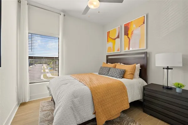 a bedroom with a bed and wooden floor