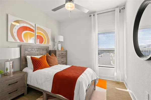 a bedroom with a bed and a painting on the wall