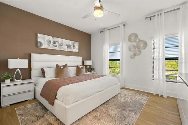 a bedroom with a bed and a chandelier