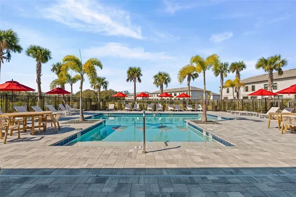 a view of a house with entertaining space and a car park in front of it