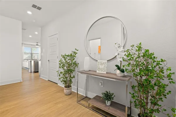 a room with painting on the wall and a potted plant