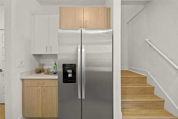 a kitchen with a refrigerator and a sink