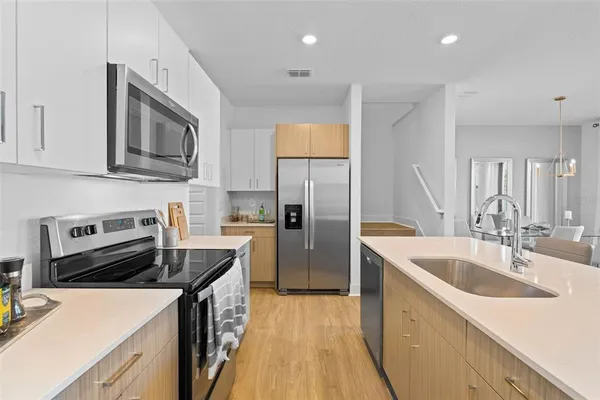 a kitchen with a sink stove and refrigerator