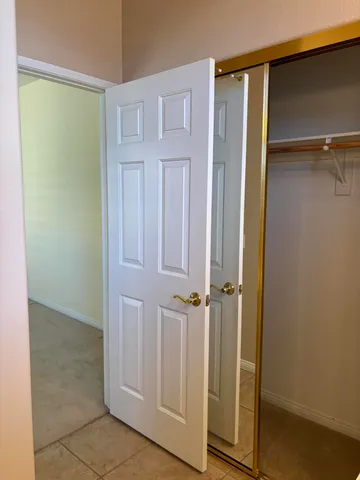 a kitchen with white cabinets and sink