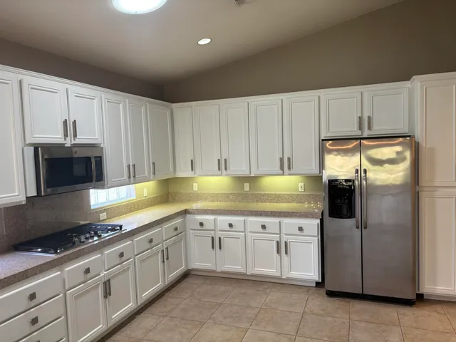 a bathroom with a granite countertop toilet and a sink