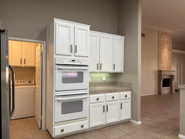 a view of an empty room with wooden floor and a floor to ceiling window