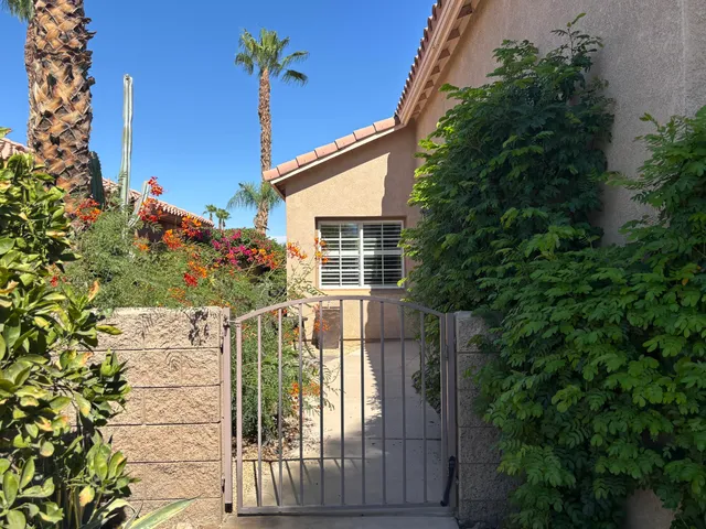a building outdoor space with patio furniture and potted plants