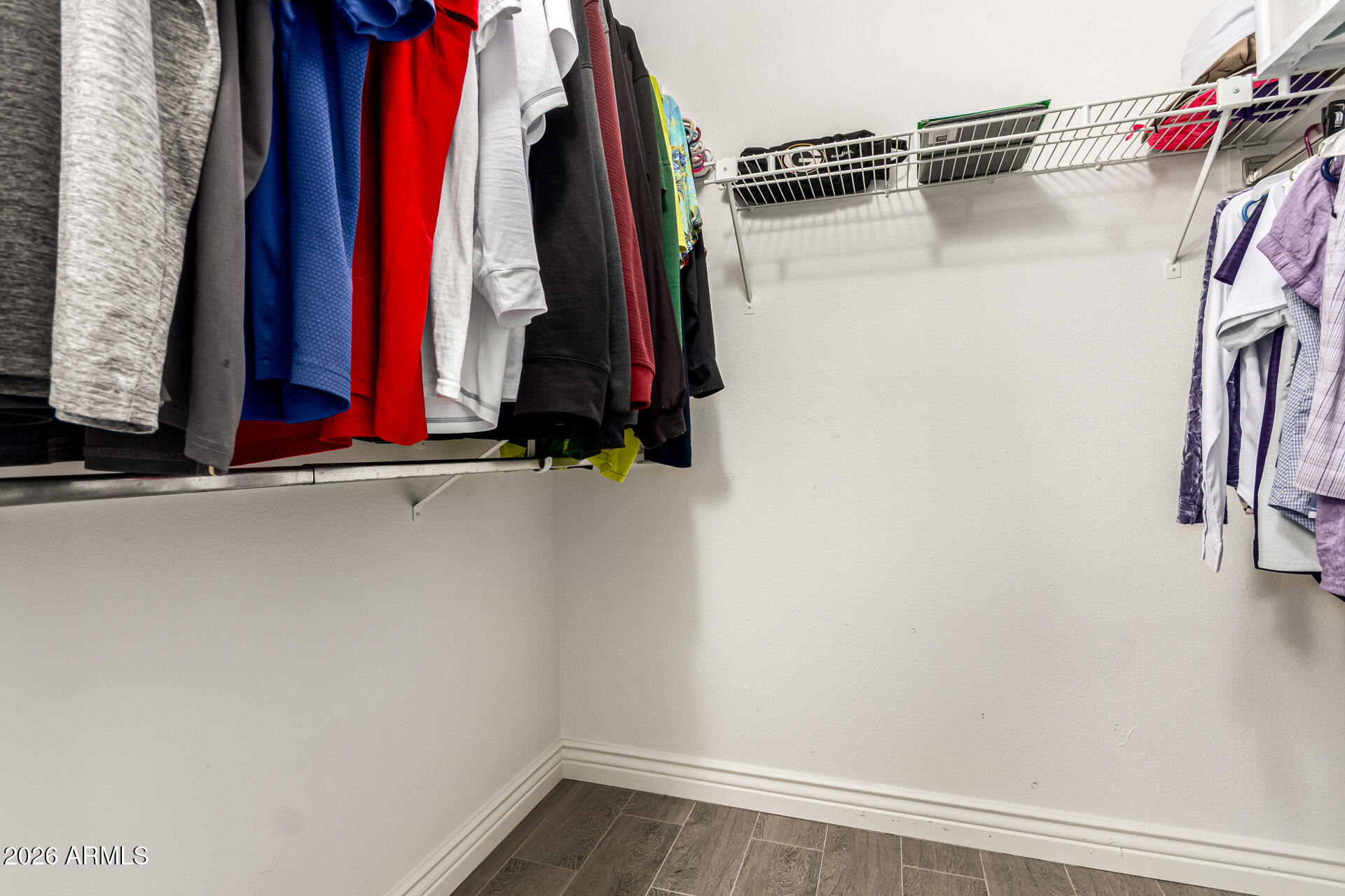 19618 North Star Ridge Drive Sun City West, AZ 85375 - Photo 24 of 37 a view of walk in closet with clothes
