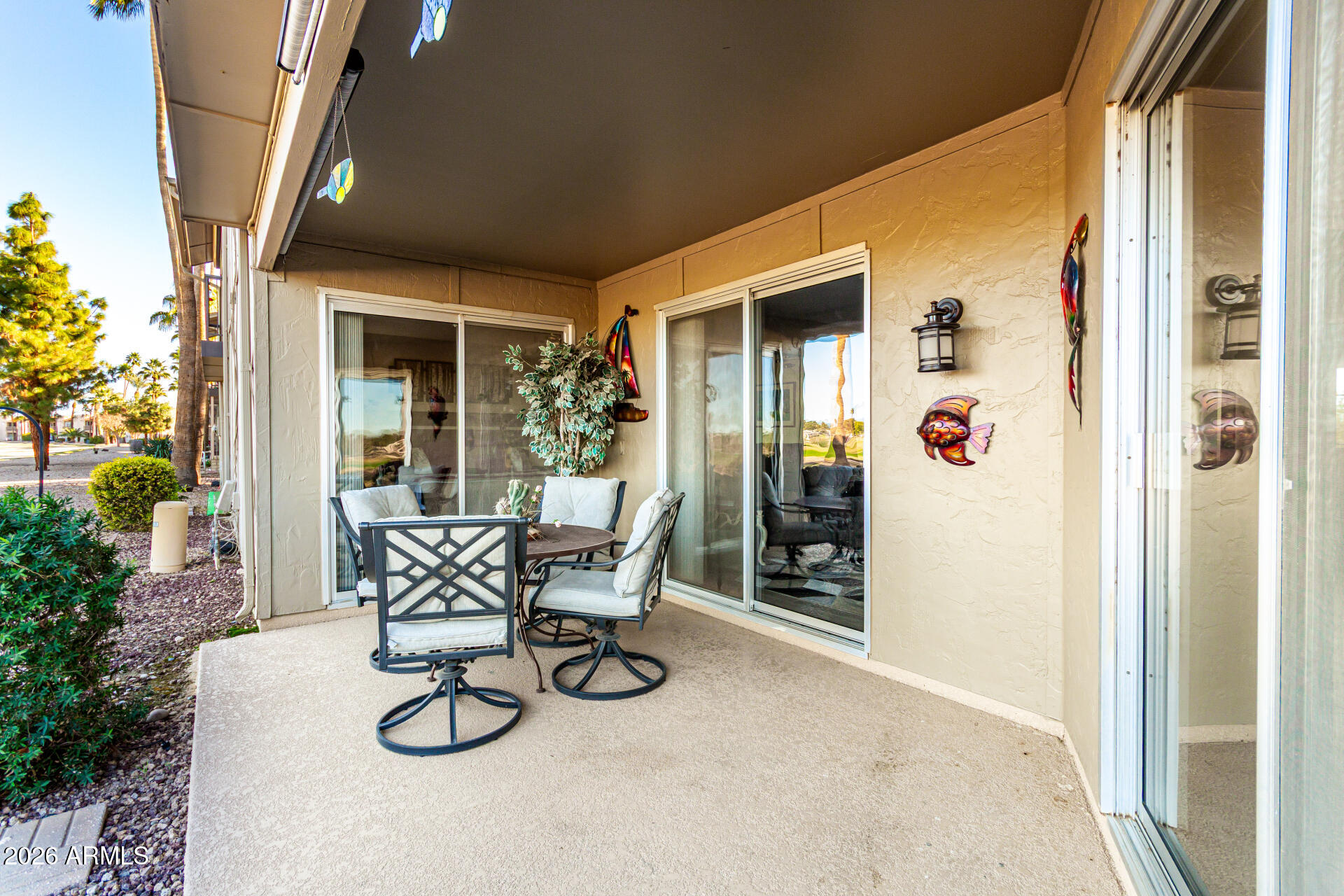 19618 North Star Ridge Drive Sun City West, AZ 85375 - Photo 28 of 37 a view of a patio with table and chairs and potted plants