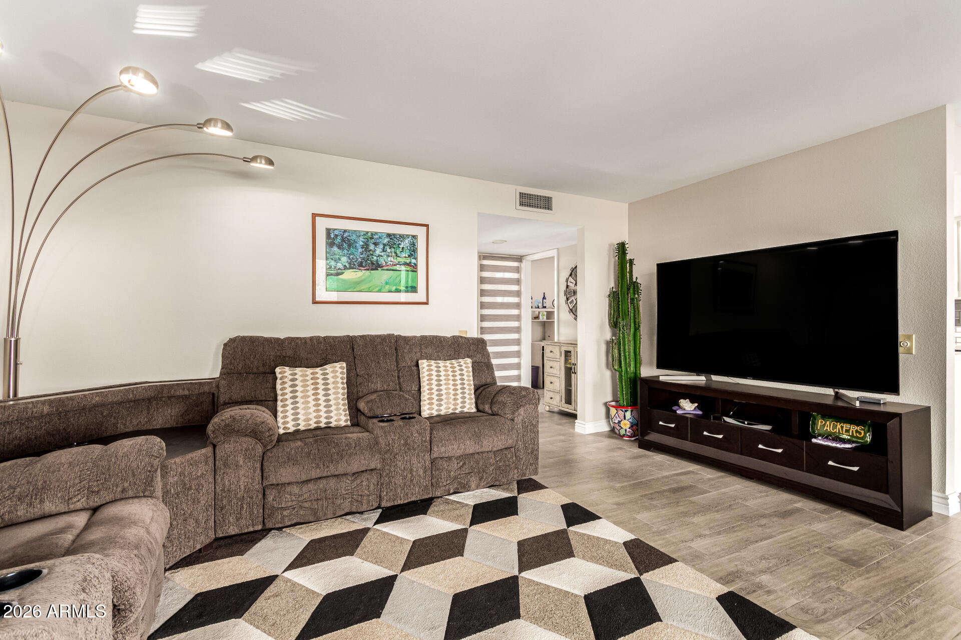 19618 North Star Ridge Drive Sun City West, AZ 85375 - Photo 9 of 37 a living room with furniture and a flat screen tv