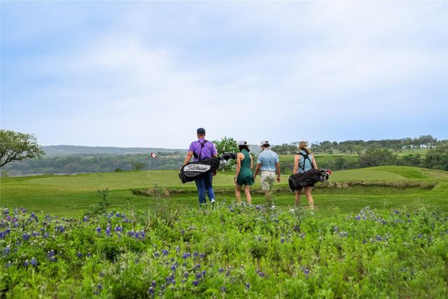 a living room with patio furniture and a floor to ceiling window
