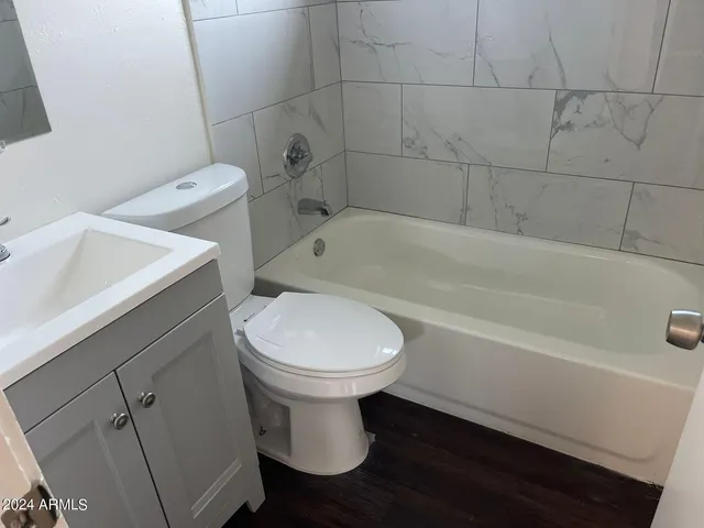 a bathroom with a sink a toilet and bathtub