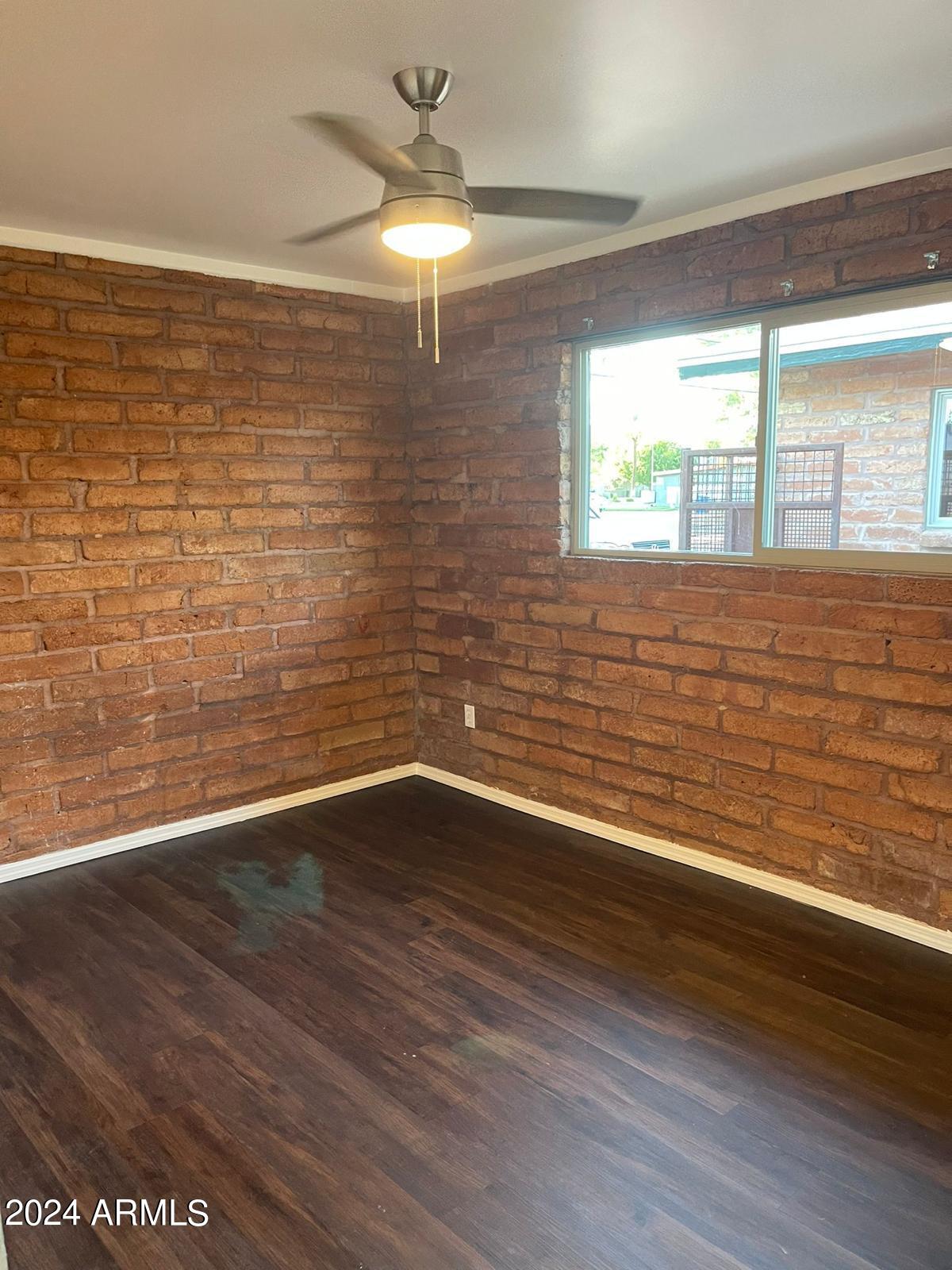 1006 South Dorsey Lane, Unit 16 Tempe, AZ 85281 - Photo 5 of 10 a view of empty room with wooden floor and fan