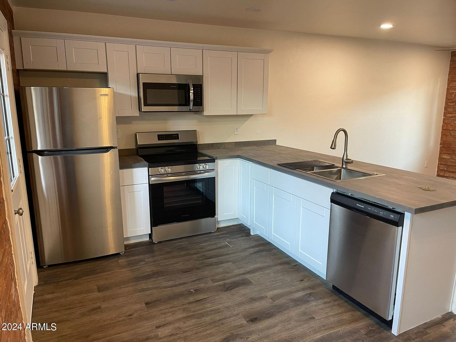 1006 South Dorsey Lane, Unit 16 Tempe, AZ 85281 - Photo 7 of 10 a kitchen with a sink and a refrigerator