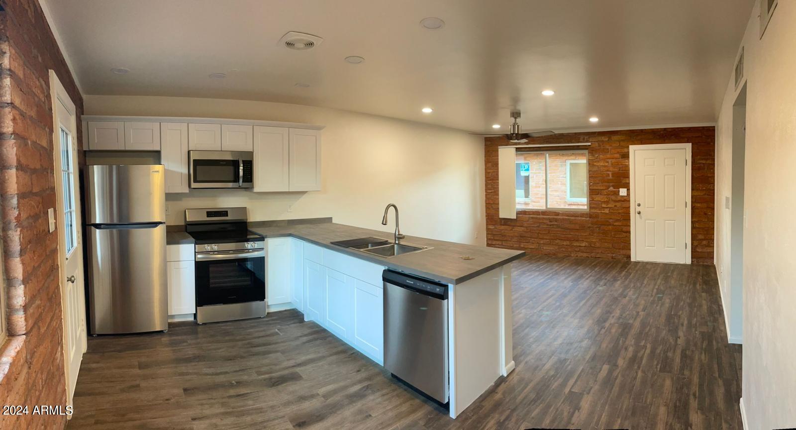 1006 South Dorsey Lane, Unit 16 Tempe, AZ 85281 - Photo 8 of 10 a kitchen with stainless steel appliances granite countertop a sink stove and refrigerator