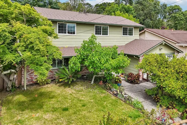 a aerial view of a house with a yard and sitting area