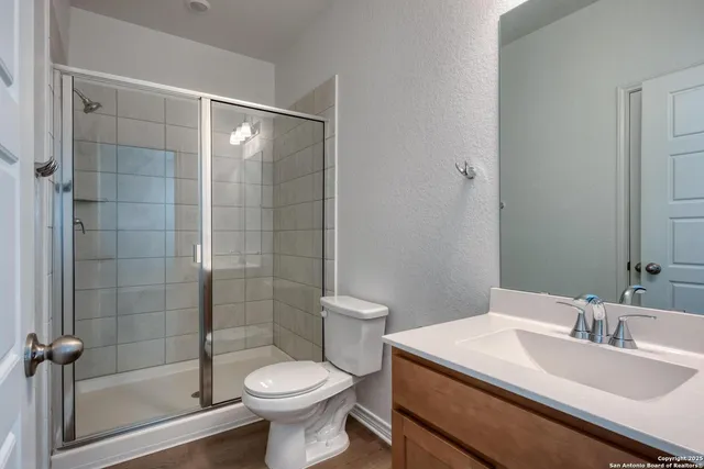 a bathroom with a sink toilet and shower
