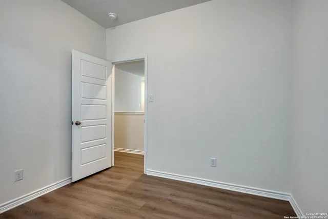 an empty room with wooden floor
