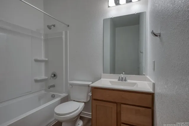 a bathroom with a sink toilet vanity and shower