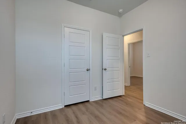 a view of an empty room and wooden floor
